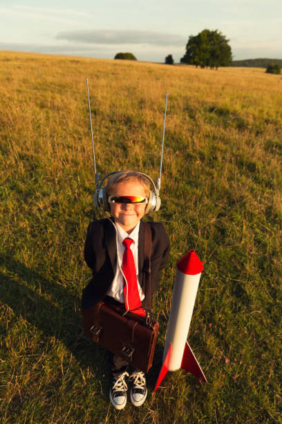 istock Young Boy Businessman Ready to Launch Rocket 653781706