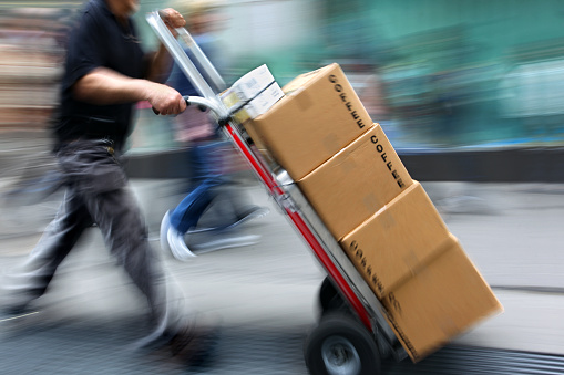 delivery goods with dolly by hand, purposely motion blur