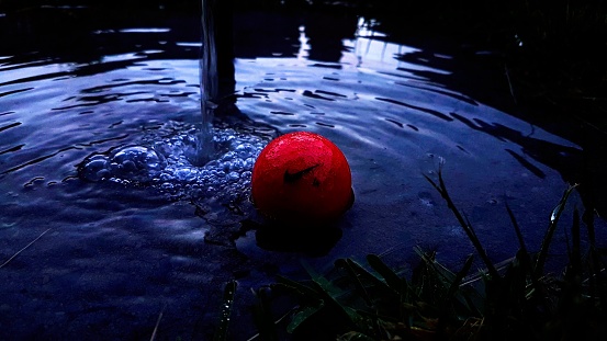 Photo of golf ball beside flowing water