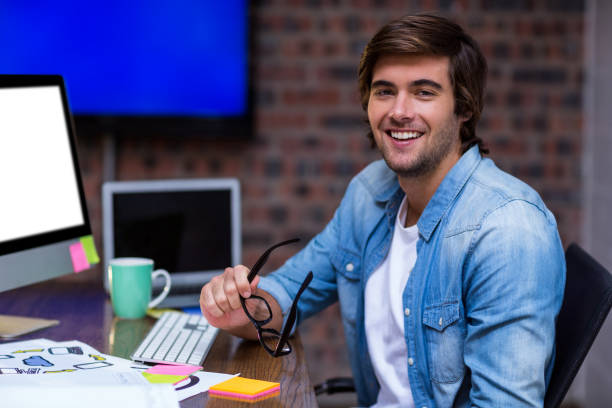 istock Young businessman sitting at desk 653786020