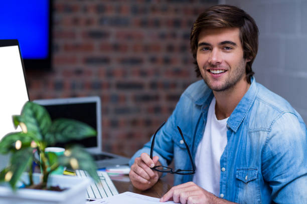 istock Young businessman at desk in office 653786108