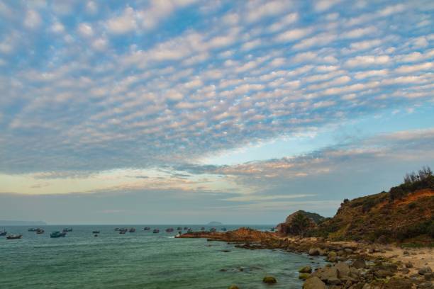 A rocky coastline looking out over the south China sea in Vung Lam Bay Vietnam. With a beautifully cloud formation at sunset.