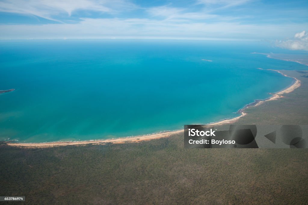 The Arafura Sea lies west of the Pacific Ocean overlying the continental shelf between Australia and Indonesian New Guinea. The beautiful scenery view at the edge of northern part of Australia called Arafura sea, Northern Territory state of Australia view from airplane. Above Stock Photo