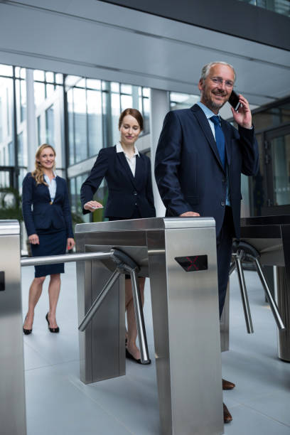 istock Businesspeople scanning their cards at turnstile gate 653788102