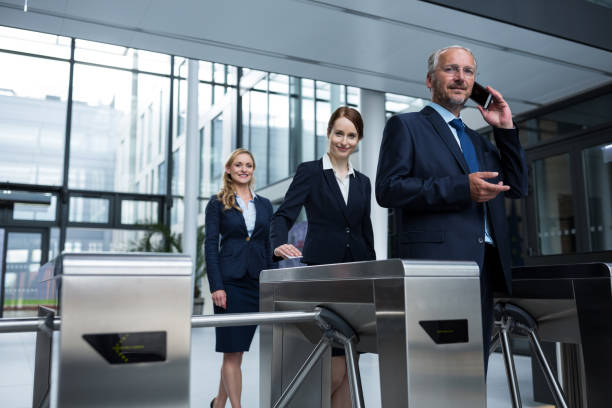 istock Businesspeople scanning their cards at turnstile gate 653788150