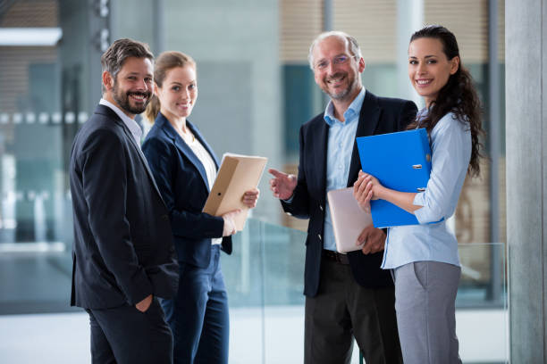 istock Happy businesspeople standing in office lobby 653788642