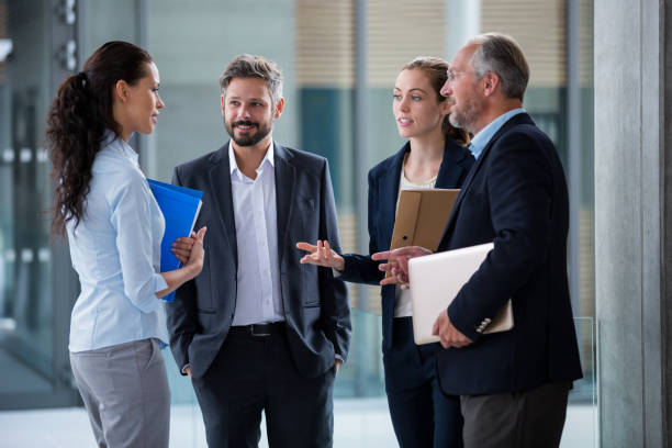 istock Businesspeople having a discussion in office corridor 653788794