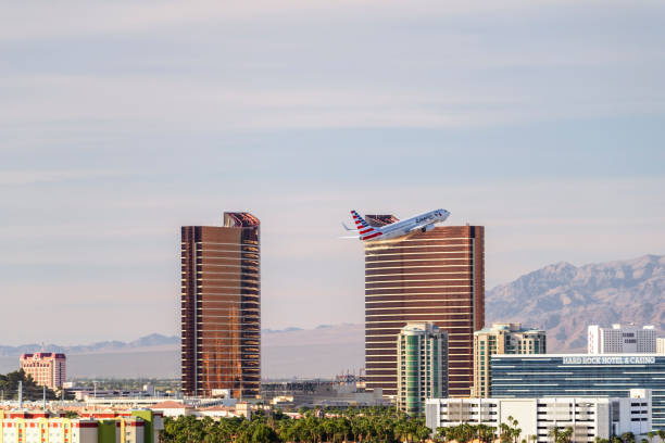 Las Vegas Hotel Casino Buildings with airplane taking off. Las Vegas, USA - March 12,2017: Telephoto shot of Buildings of Las Vegas Hotel & Casino. Passenger jet airplane taking off from Mccarran International Airport  in the foreground .Las Vegas is world famous for nigth entertainment show and convention center. wynn las vegas stock pictures, royalty-free photos & images
