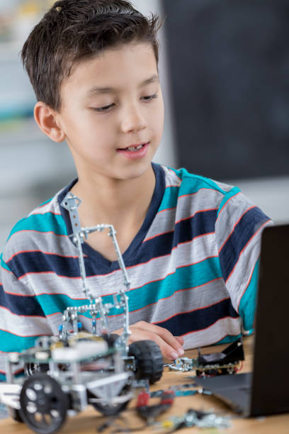 istock Boy creates robotic vehicle at school 653791964