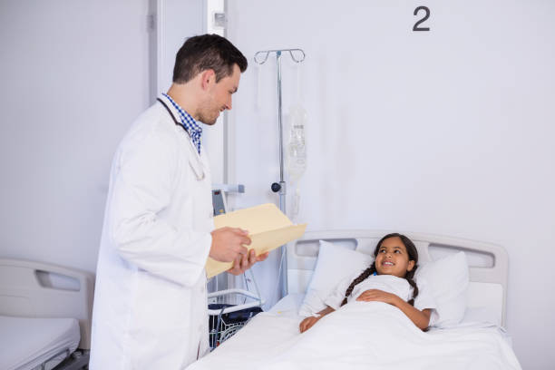 istock Doctor talking to a girl patient 653792300