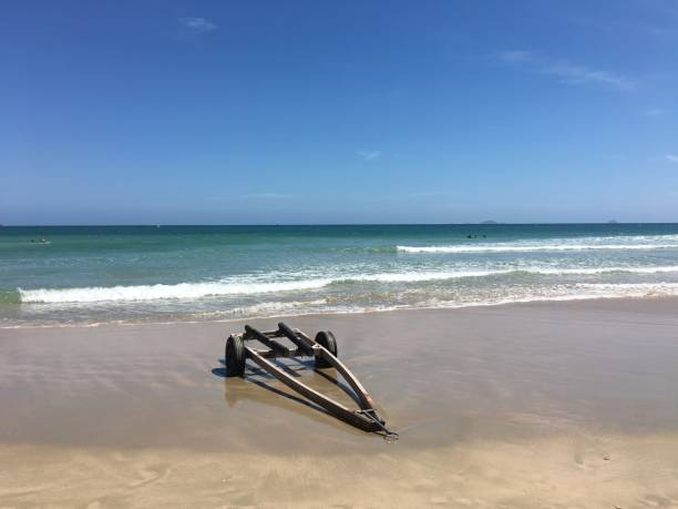 istock The wheelbarrow on the beach with sea wave foam 653798572