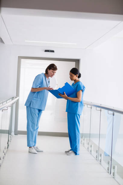 istock Nurse and doctor discussing over clipboard 653798672