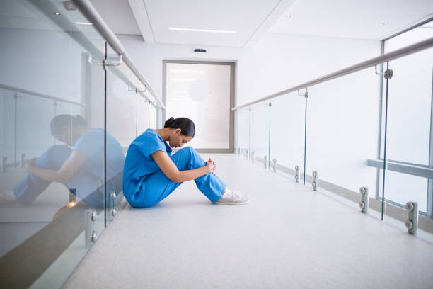 istock Rear view of nurse standing with hands on hip 653798716