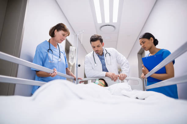 istock Doctors examining patient in corridor 653799386