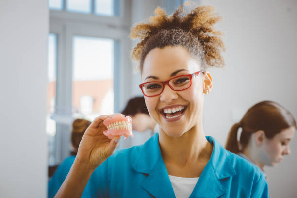 istock Cheerful afro american student holding denture 653799792