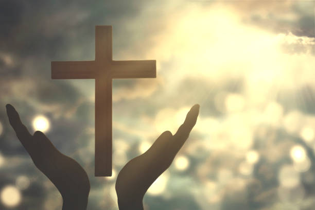 istock Hands with cross worshiping to the GOD 653799974