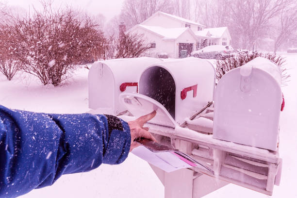 istock Man's Hand Closing Winter Blizzard Snow Rural Mail Box 653800780