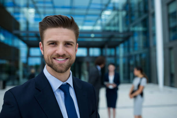 Portrait of happy businessman Portrait of happy businessman in office premises sales executive stock pictures, royalty-free photos & images