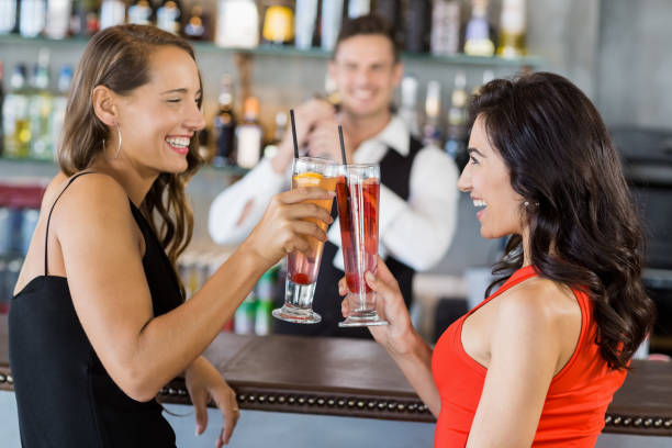 istock Beautiful women toasting cocktail glasses 653804158