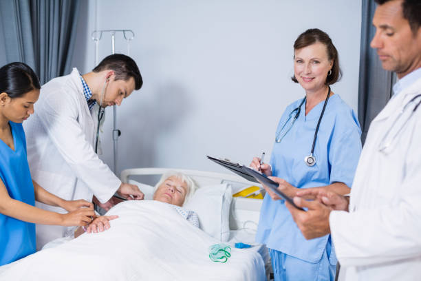 istock Doctors examining patient in ward 653805108