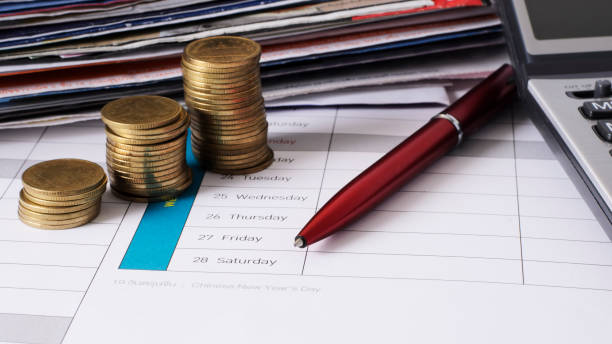 istock money coins stack and red pen for due date payment concept background 653809342