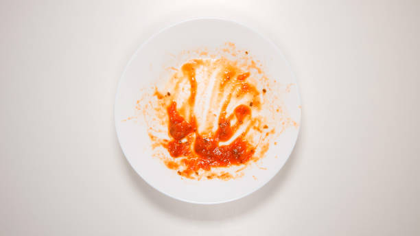 TOP VIEW: Empty and dirty dish after a spaghetti with tomato sauce