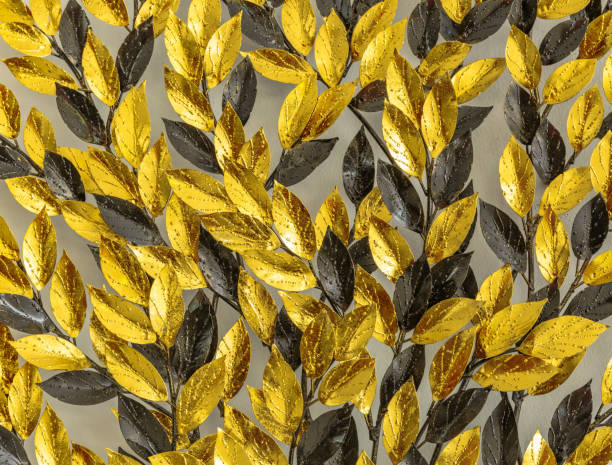 istock Close up Gold and black artificial leaf on wall 653810816