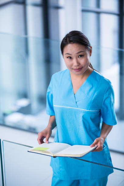 istock Nurse holding a diary in hospital 653810966