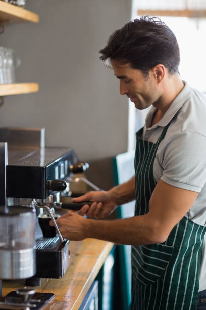 istock Waiter making cup of coffee 653811648