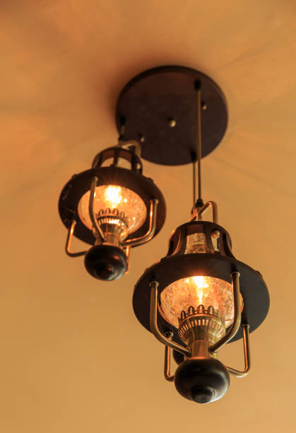 istock Yellow lamps with glass structure on ceiling in ballroom 653811758
