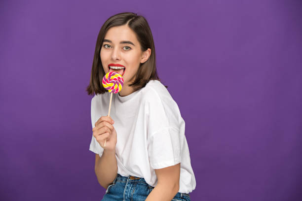 istock The young woman with colorful lollipop 653814976