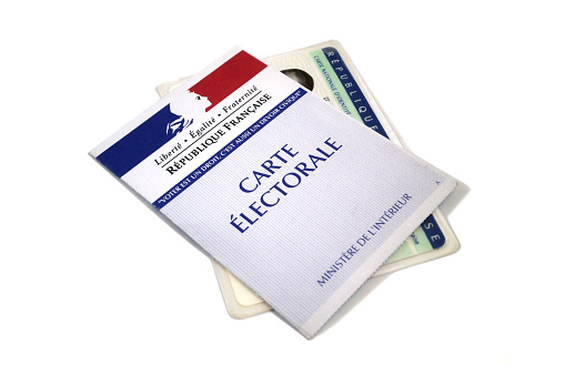 Paris, France - March 15 2017: Close up of an electoral card and ID card isolated on white background. Perfect to illustrate an article on the upcoming French presidential elections or any other elections in France.