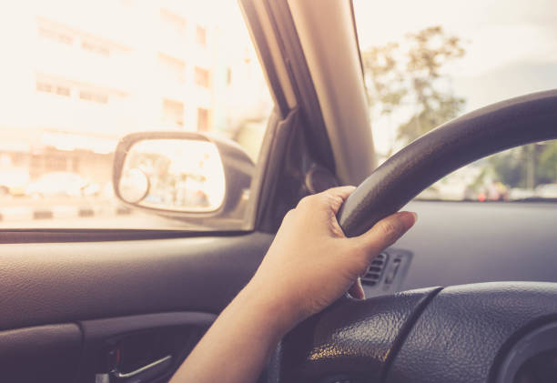 istock woman driving car on the road 653818250