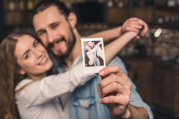 istock Couple with instant photo 653818338