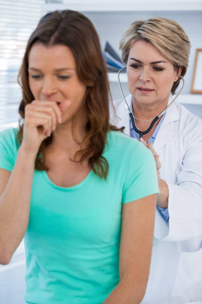 istock Doctor examining coughing patient with stethoscope 653818972