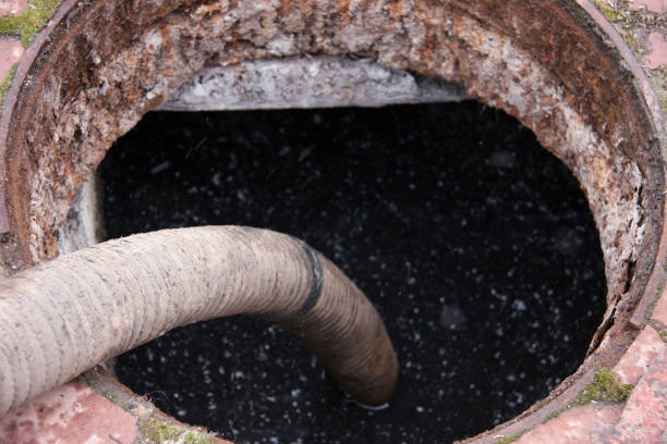 istock pumping sewage from the drain hole 653819286