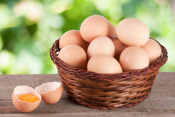 istock eggs in a wicker basket on a wooden board with blurred garden background 653820168