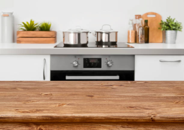 istock Brown wooden table on defocused pastel color kitchen interior background 653821466
