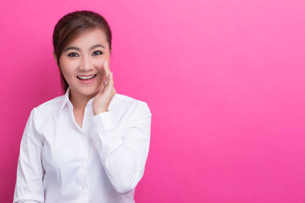 istock Happy asian woman make the gossip gesture 653825408