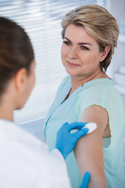 istock Doctor rubbing patient arm from cotton before injection 653826878