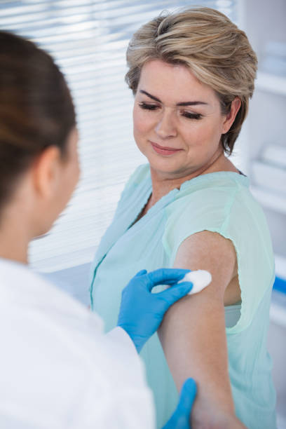 istock Doctor rubbing patient arm from cotton before injection 653826938
