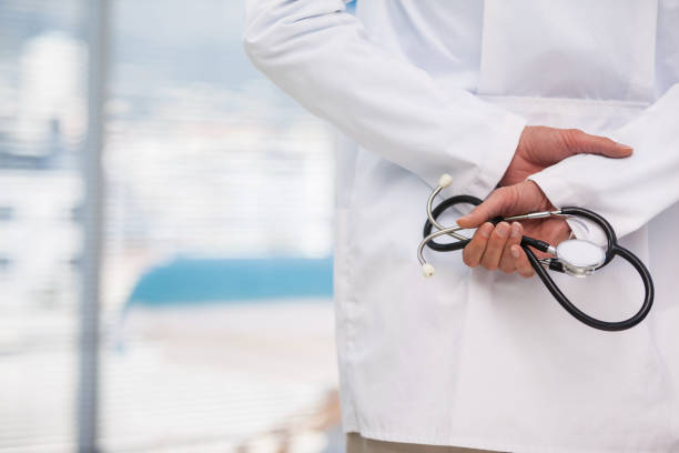 istock Mid-section of doctor holding stethoscope 653827612