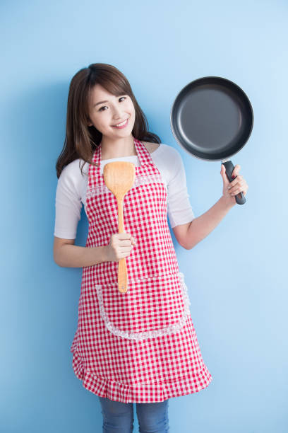 istock housewife take wok and spoon 653828730