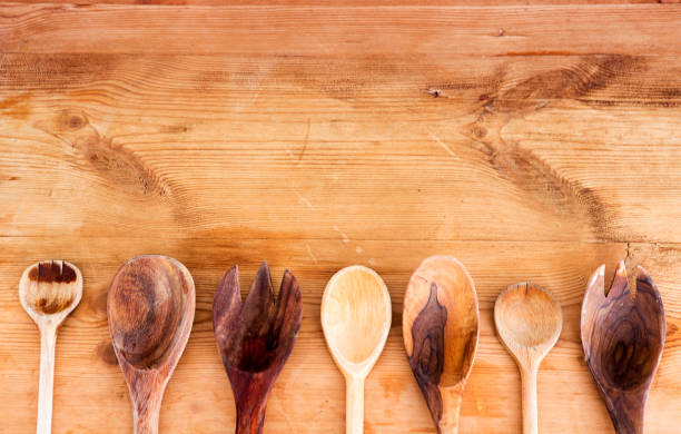 istock cooking spoons lined up on wooden table 653829316