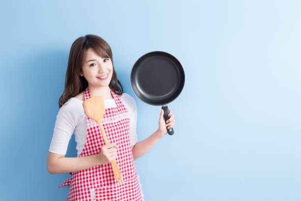 istock housewife take wok and spoon 653831338