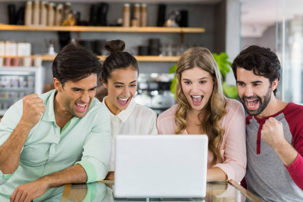istock Group of excited friends using laptop 653831552