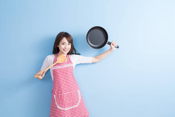 istock housewife take wok and spoon 653831780