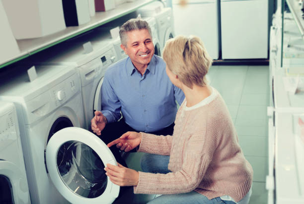 istock Married couple selecting home modern washing machine 653833736