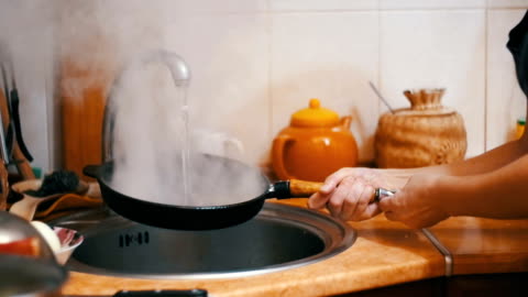 Wash Hot Frying Pan Turns A Jet Of Cold Water Into Steam In A Sink Of Home Kitchen Slow Motion Stock Video - Download Video Clip Now - iStock