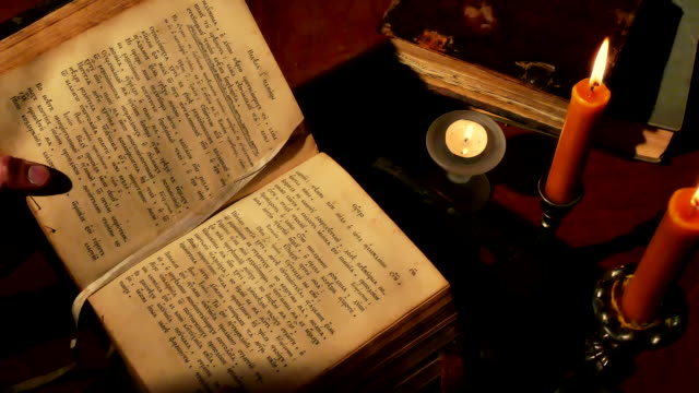 Reading Old Book Under Candlelight